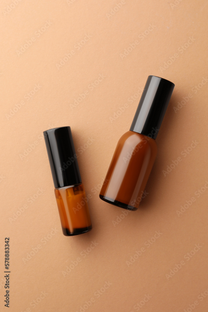 Obraz premium Bottles of face cream on beige background, flat lay