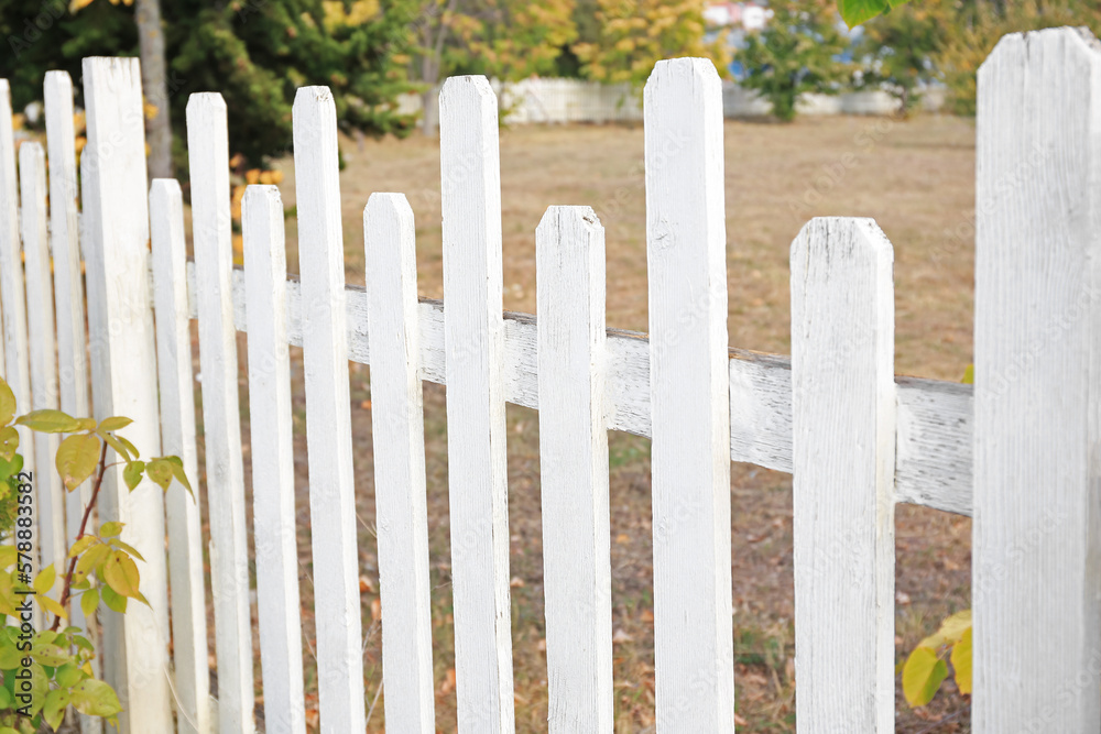 Beautiful white wooden fence outdoors on sunny day Beautiful white wooden fence outdoors on sunny day