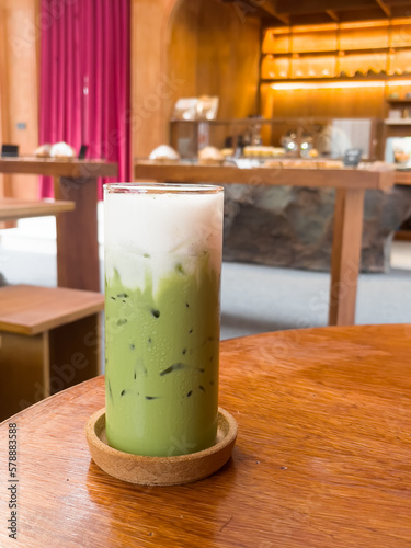 Iced matcha greentea on wooden table in coffee shop