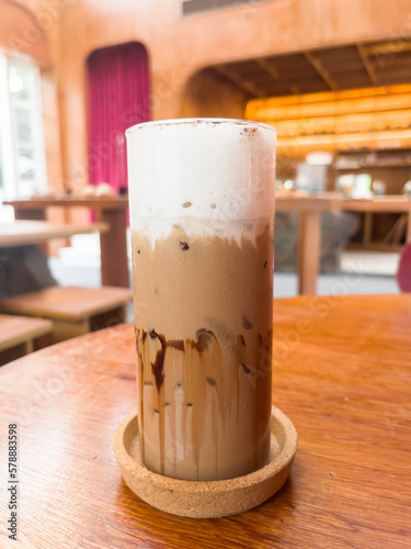 Iced coffee mocha on wooden table in coffee shop