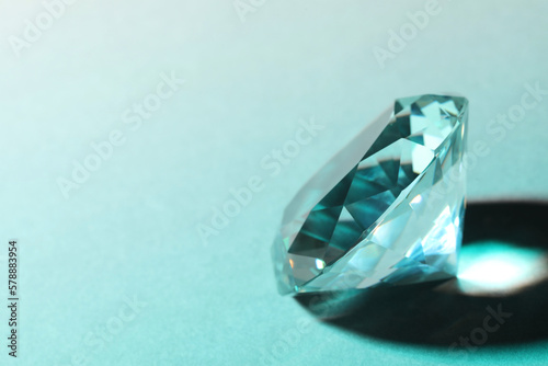 Beautiful dazzling diamond on light background  closeup. Space for text