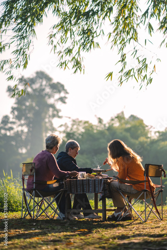 mother and children lifestyle in vacation camping concept, nature, woman person family are happy fun to eating picnic breakfast food at outdoors summer travel, girl with adventure trip holiday leisure