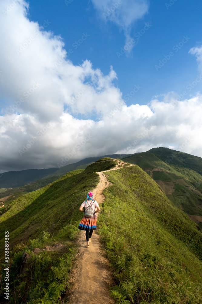 Hiking tourists explore the trail on spine and the top of the mountains Ta Xua. This is a very popular tourist destination in VN