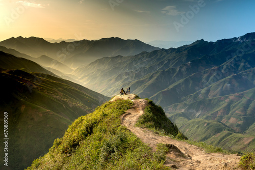 Hiking tourists explore the trail on spine and the top of the mountains Ta Xua. This is a very popular tourist destination in VN photo