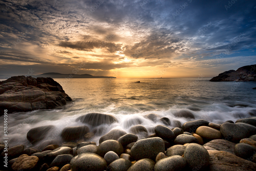 Long exposure of sea and stones, beautiful sunrise in Quy Nhon city, Vietnam