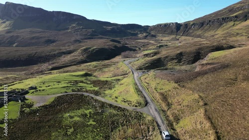 Following cars on Highland road through Quiraing rock formations at the Trotternish Ridge Isle of Skye Scotland photo