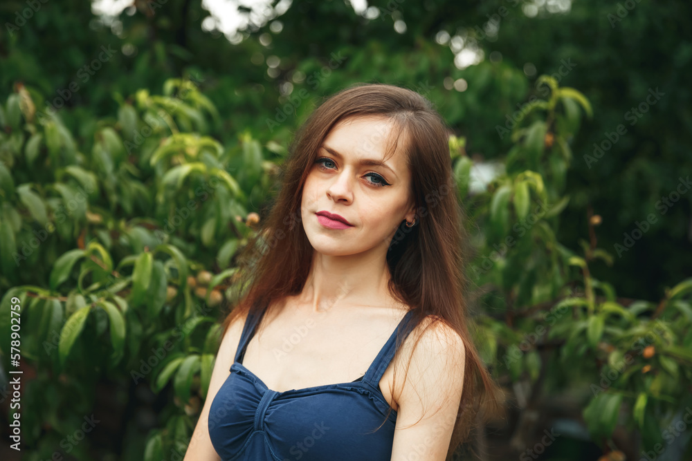 A girl standing outside in nature. Portrait of cheerful woman A girl standing outside in nature. Portrait of cheerful woman