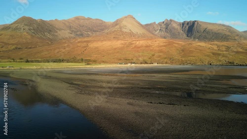 Flying low over beach towards Red Cuillin mountains at sunset at Glenbrittle Isle of Skye Scotland photo