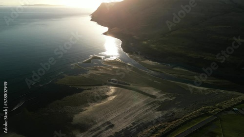 Flying down to gravel beach with high reflections at Glenbrittle Isle of Skye Scotland photo