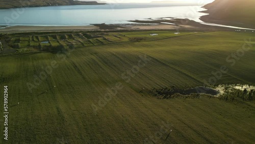 Flying over smooth fields towards beach at sunset at Glenbrittle Isle of Skye Scotland photo