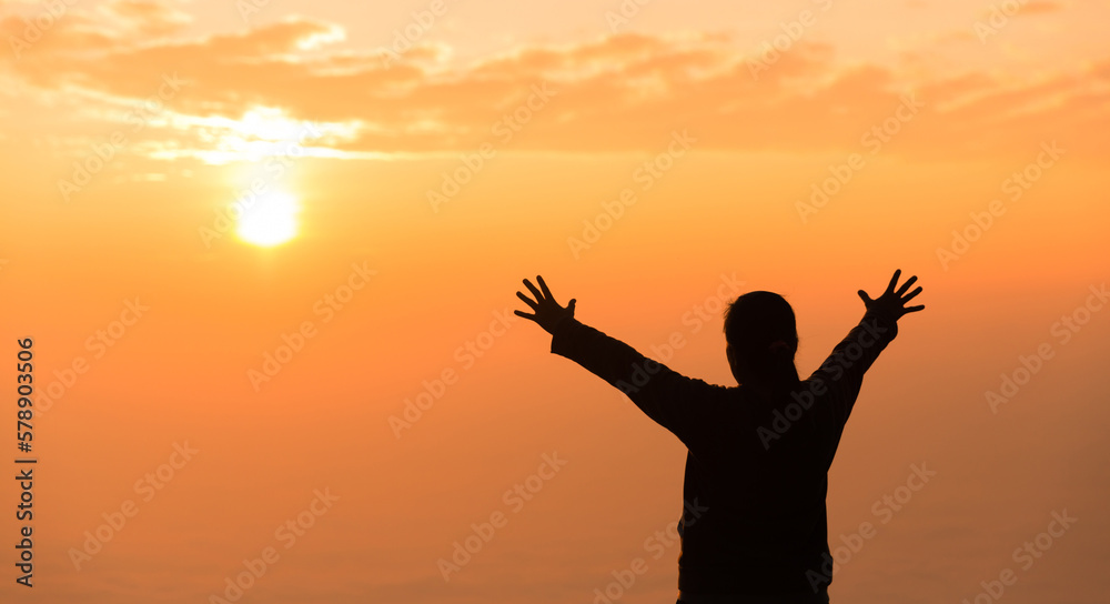 Silhouette of woman raising her hand praying spirituality and religion, banner and copy space of female worship to god. Christianity religion concept.Christians person are pray humility humble to god.