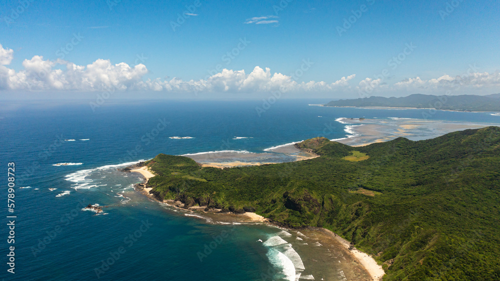 Top view of tropical island with jungle and blue sea. Cape Engano. Palaui Island. Santa Ana Philippines.