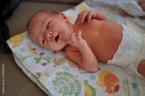 Above shot of newborn baby lying on blanket