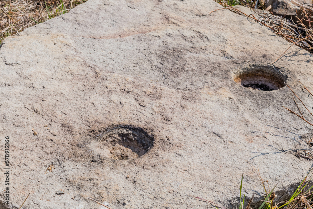 Obraz premium Flat boulder with post holes used in ancient stone fortress in Yeosu, South Korea.