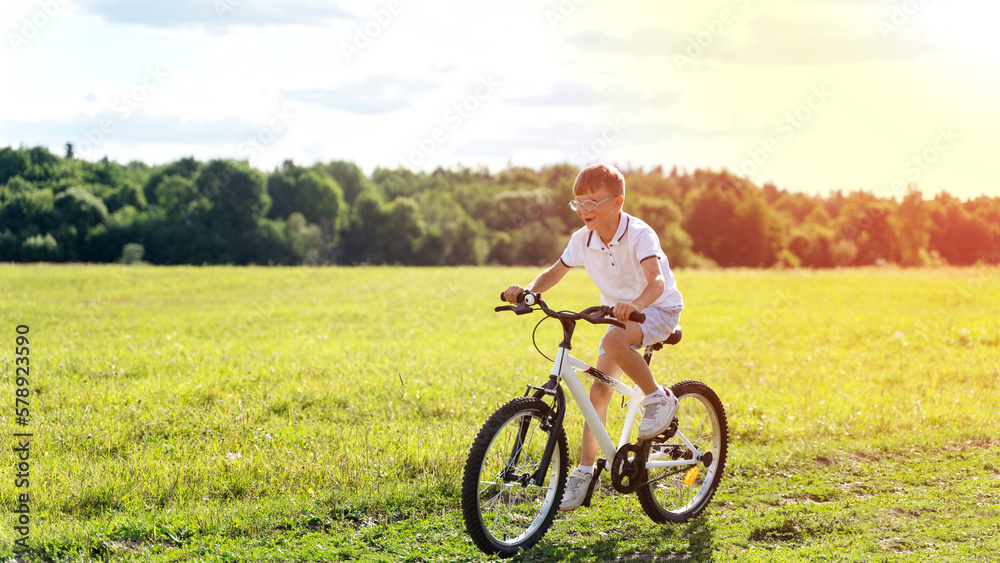 Fototapeta premium a boy rides a bicycle in nature