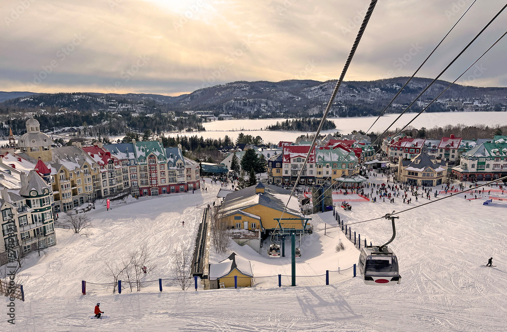 Fototapeta premium Mont Tremblant village and lake in winter with funiculars in foreground, Quebec, Canada