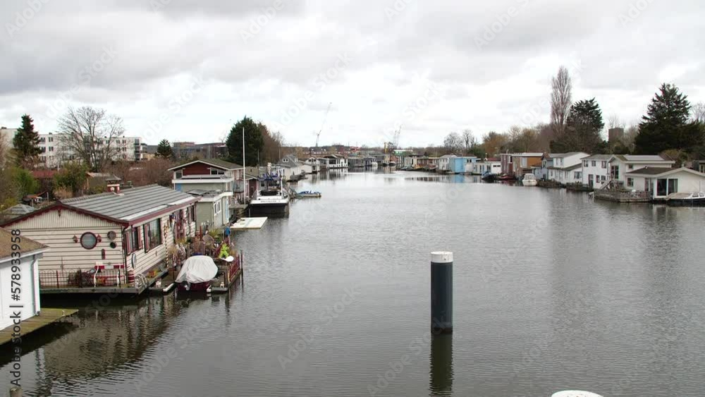 zoom in on houseboats in the Netherlands on a wide canal zoom in on houseboats in the Netherlands on a wide canal