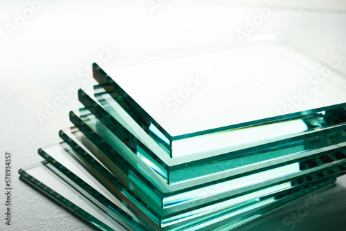 several sheets of clear glass Different thicknesses on a white background. Close-up.