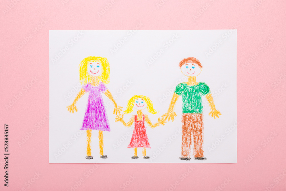 Drawn father, mother and daughter shapes with colorful wax crayons on white paper sheet on light pink table background. Pastel color. Closeup. Happy loving family concept. Top down view. Drawn father, mother and daughter shapes with colorful wax crayons on white paper sheet on light pink table background. Pastel color. Closeup. Happy loving family concept. Top down view.