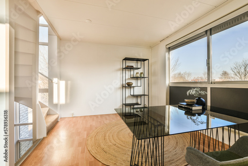 a living room with wood flooring and large windows looking out onto the cityscapea is on the wall photo