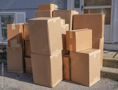 Obraz na plátně stacking delivered package boxes in front of the front door of house