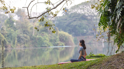 Asian woman doing yoga in nature in the forest, Meditation and breathing exercises, Treat ADHD and train your mind to be calm, Healthy exercise, Mindfulness, Homeopathy, Park yoga.