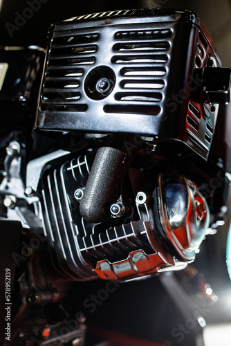 Black motorcycle carburetor on engine © Kaspars