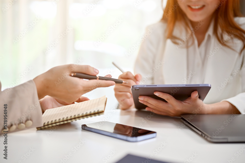 Cropped image of professional millennial Asian female boss is in the meeting with her team Cropped image of professional millennial Asian female boss is in the meeting with her team