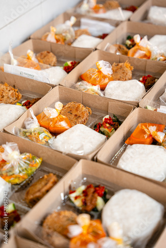 In Indonesian it is called Rice Box or Nasi kotak with perkedel kentang. Usually distributed during celebrations or catering packaging. photo