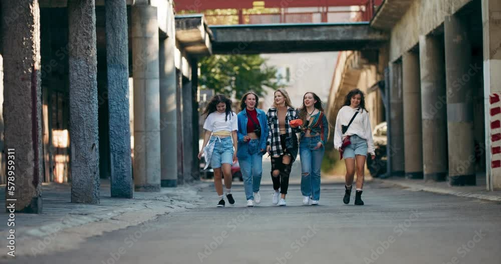 Slow motiong action selective focus happy girls classmate in differen stylish fashionable clothes jeans denim walking arouung on street having fun together friendship reunion. Slow motiong action selective focus happy girls classmate in differen stylish fashionable clothes jeans denim walking arouung on street having fun together friendship reunion.