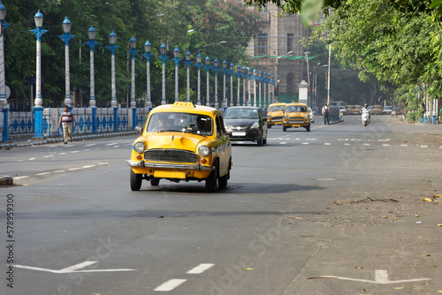 Vintage yellow taxi on the roads of Kolkata, India photo