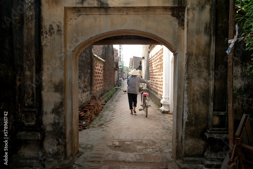 Old aged house entrance and wall made of laterite in Duong Lam ancient village, Son Tay district, Hanoi, Vietnam