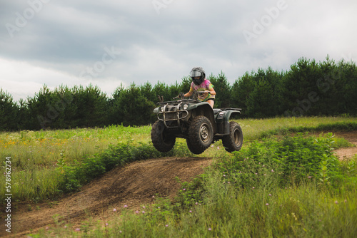 teen girl catching air on atv track in northwestern wi photo