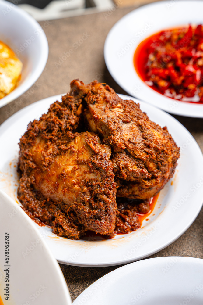 Rendang Ayam or Chicken Rendang, is an Indonesian food from West Sumatra in Indonesia.
Chicken Rendang served on white plate Rendang Ayam or Chicken Rendang, is an Indonesian food from West Sumatra in Indonesia.
Chicken Rendang served on white plate