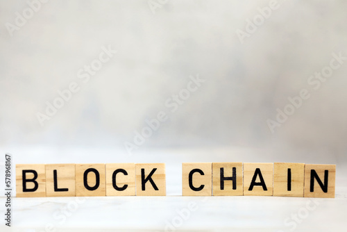 Blockchain text on wooden cubes, cryptocurrency,technology binary code, ditigal data and secure money, ledger bitcoin concept copy space background photo