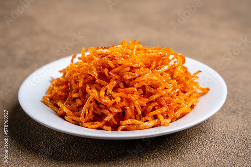 Dried potato or potato mustofa (indonesian : Kering Kentang Potato Balado) is the term for dry match-shaped potatoes stir-fried with Indonesian spices. photo