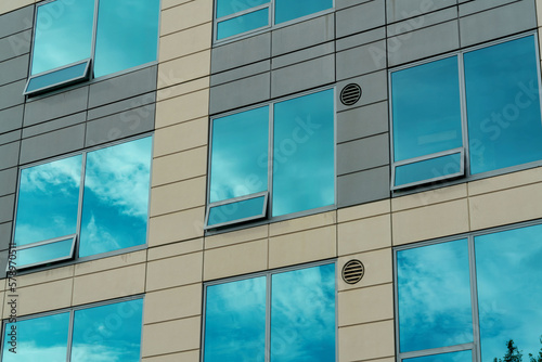 Row of reflective glass sleek windows on modern office buildings or downtown business in american city