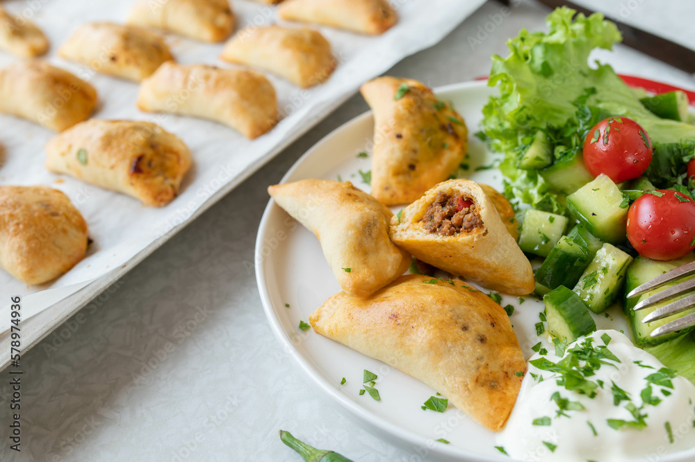 Empanadas with ground beef, cheese filling and side salad