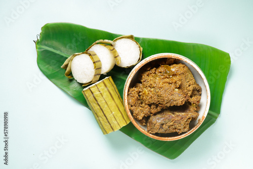 Lemang or Glutinous Rice Wrapped with Banana Leaf is a Traditional Malay Food Called Juadah Raya or Juadah Ramadan, Served with Rendang. photo