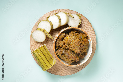 Lemang or Glutinous Rice Wrapped with Banana Leaf is a Traditional Malay Food Called Juadah Raya or Juadah Ramadan, Served with Rendang. photo