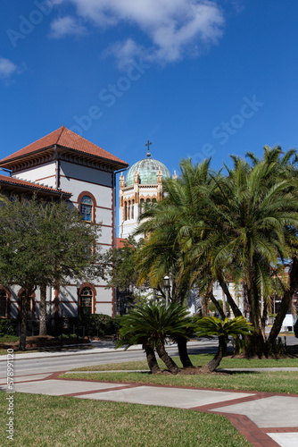 Vertical view of one of Flagler’s College Spanish Revival buildings and the dome of the 1889 Memorial Presbyterian Church seen during a sunny winter day,  St. Augustine, Florida, USA © Anne Richard