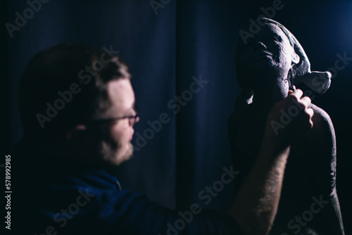 Man sculptor creates sculpt bust clay human woman sculpture. Statue craft creation workshop.