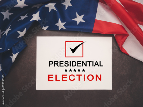 Part of the American flag with Presidential election text on white paper over a vintage background photo