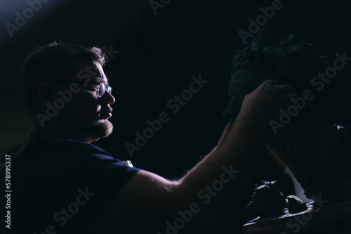 Man sculptor creates sculpt bust clay human woman sculpture. Statue craft creation workshop.