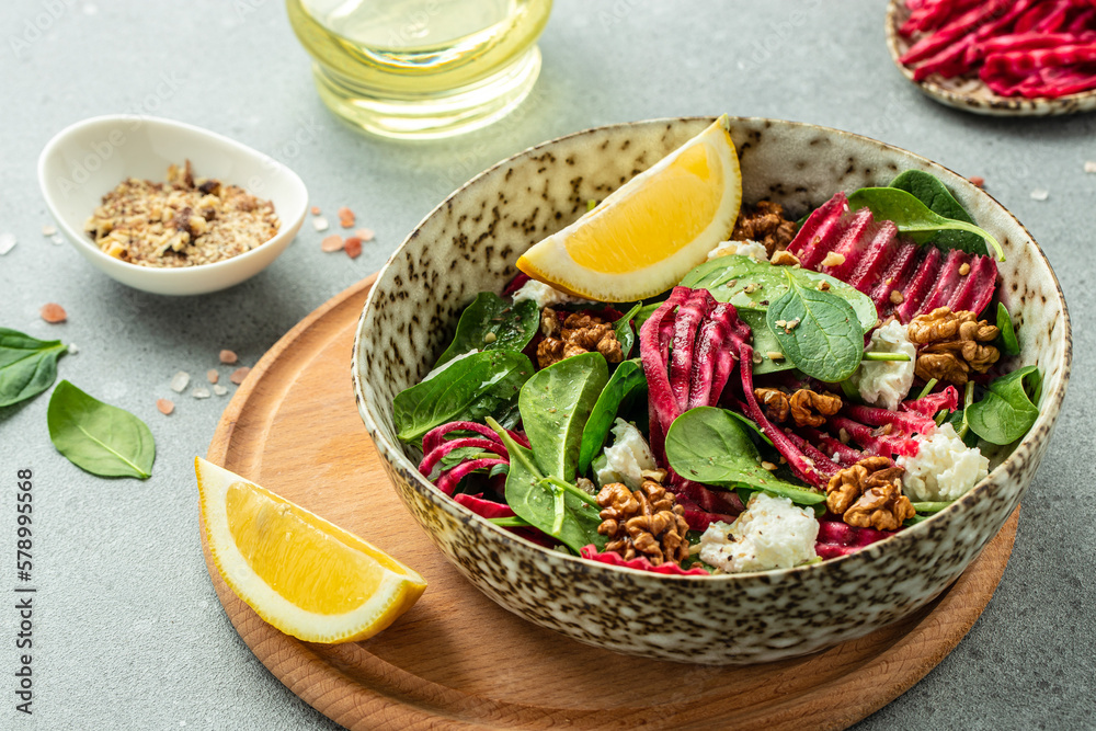 Healthy salad with baby spinach, nuts and cheese. Restaurant menu, dieting, cookbook recipe top view Healthy salad with baby spinach, nuts and cheese. Restaurant menu, dieting, cookbook recipe top view