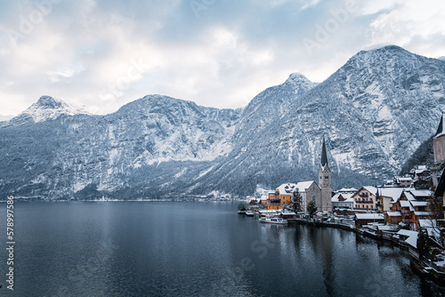 Hallstatt church in winter with mountains and the lake surrounding it. © Peter