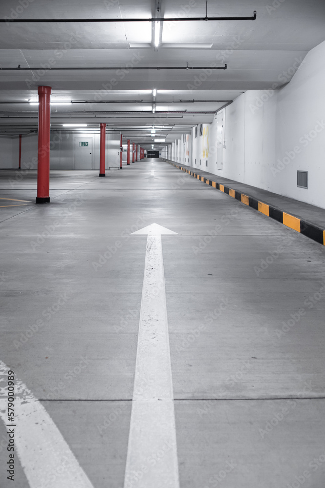 Empty underground car parking lot inEurope. Wide-angle view, neon lights, no people