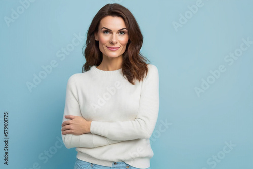 Beautiful caucasian girl standing on a blue background looking at the camera. AI generative