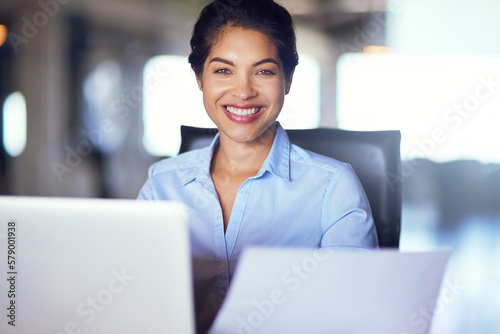Driven to suceed. Portrait of a young businesswoman working on her laptop in the office. photo