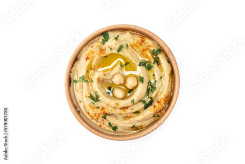 Chickpea hummus in a wooden bowl garnished with parsley, paprika and olive oil isolated on white background. top view